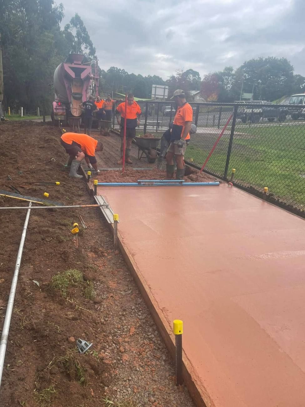 Earth-Crete crew finishing a coloured concrete pour