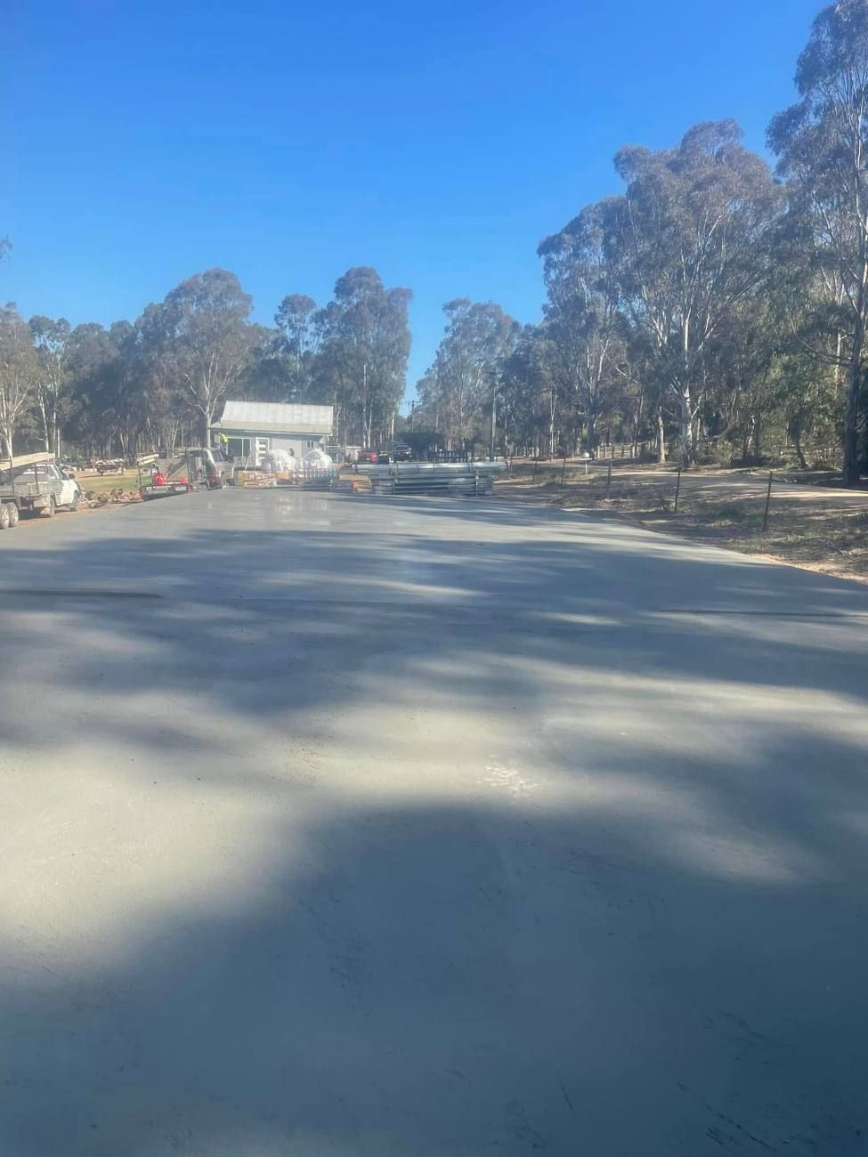 Long concrete driveway poured by Earth-Crete on a rural block