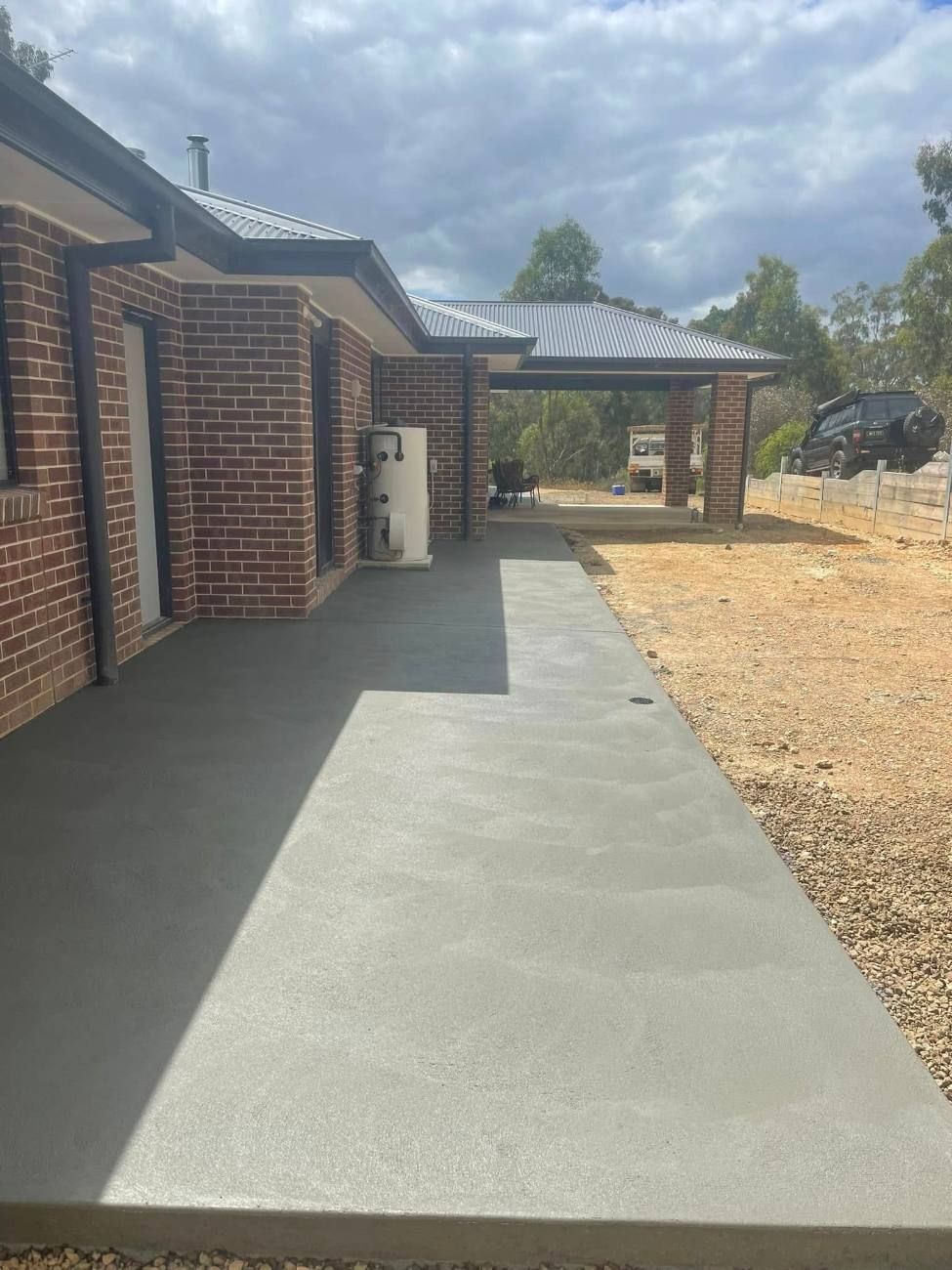 Concrete path along the side of a new brick home