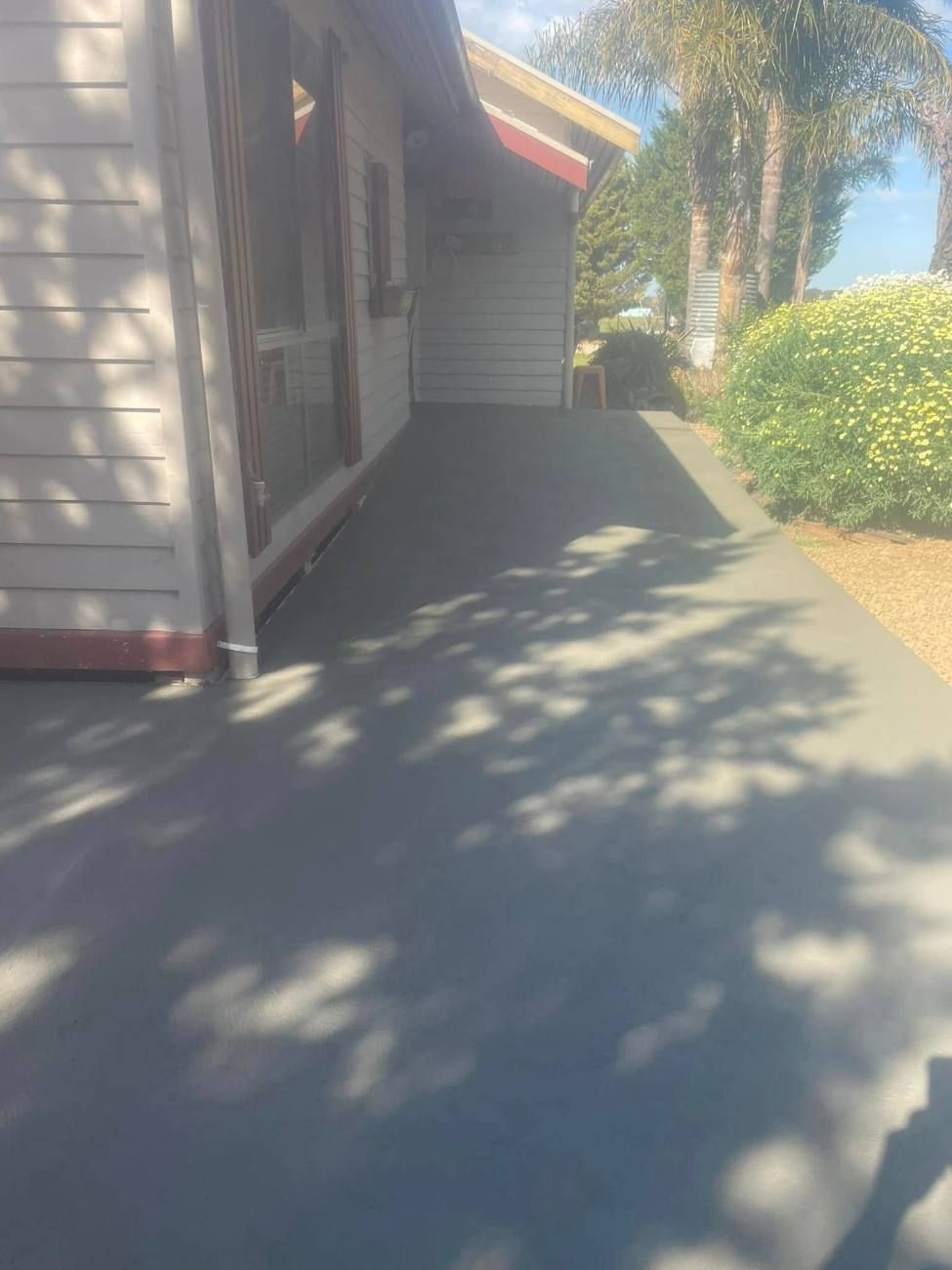 Concrete path down the side of a weatherboard house