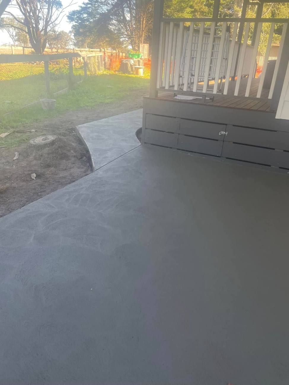 Curved concrete path leading to a verandah
