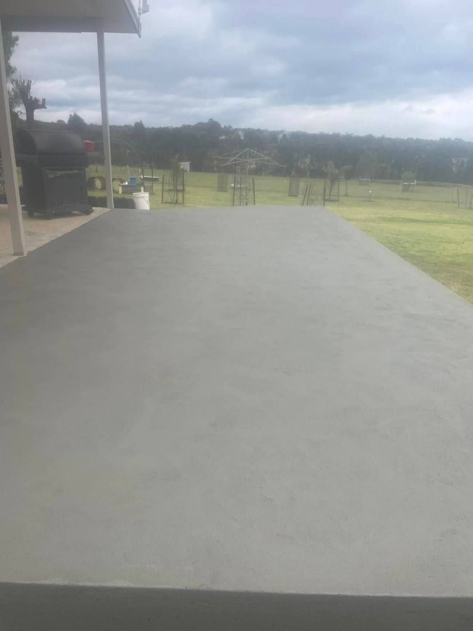 Concrete slab beside a verandah looking out over paddocks